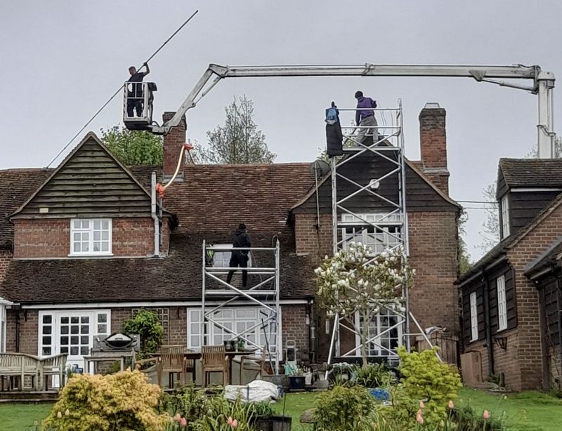 The Roof Moss Cleaners using cherry picker and scaffolding to clean roof safely and professionally in Hedge End, Hampshire
